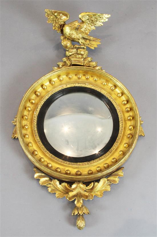 A Regency giltwood and gesso convex wall mirror, H.3ft W.1ft 10in.